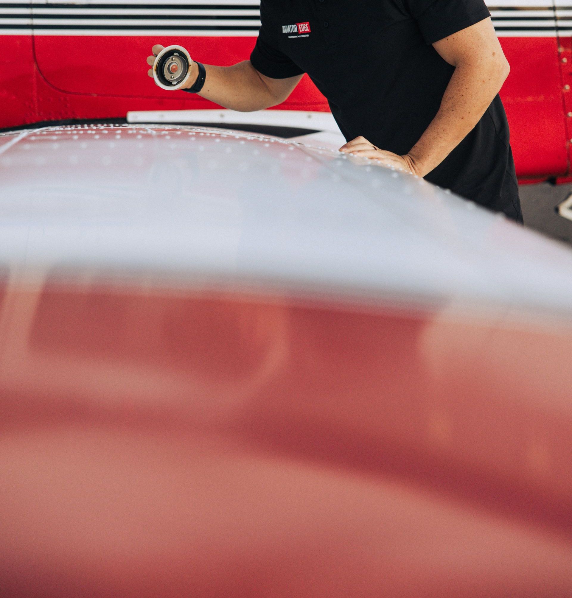 Mechanic inspecting a small airplane wing