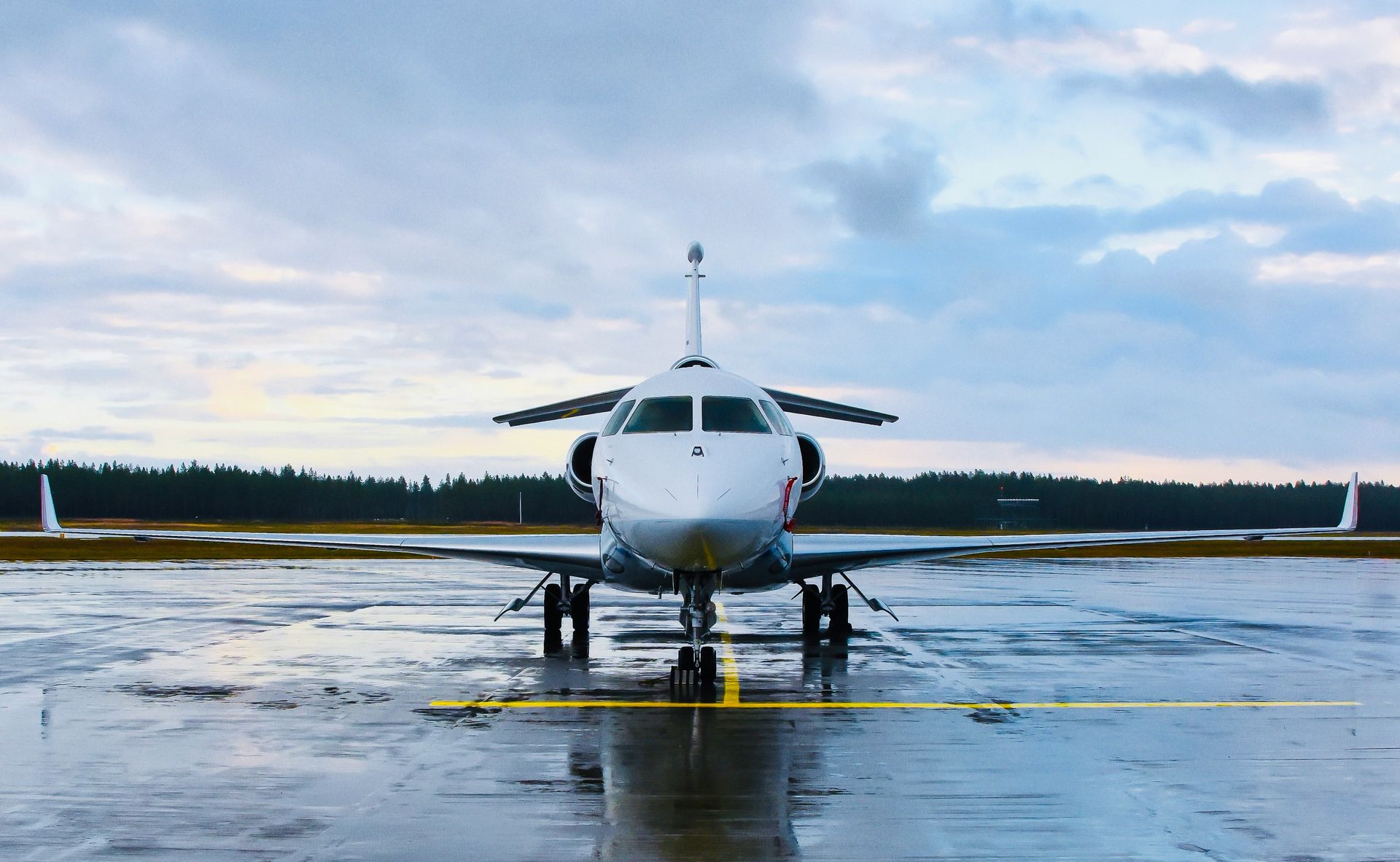 an airplane is parked on a wet runway